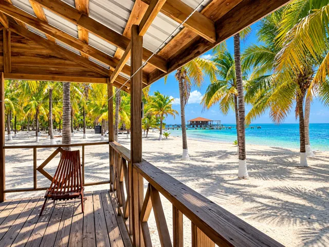 Shaded wooden veranda overlooking the palm-lined beach
