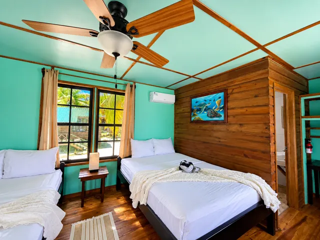 Cabana bedroom with wooden walls and turquoise trim