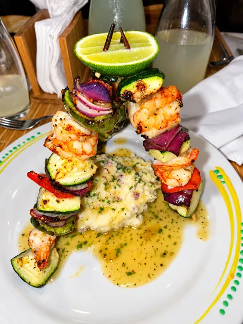 A plated shrimp-skewer meal at the resort