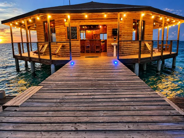 Warm evening lights along the pier and overwater bar