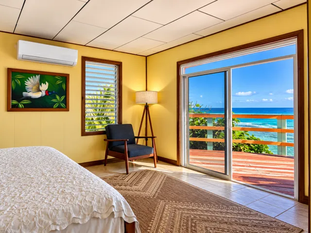 Reef House bedroom with a beachfront balcony view